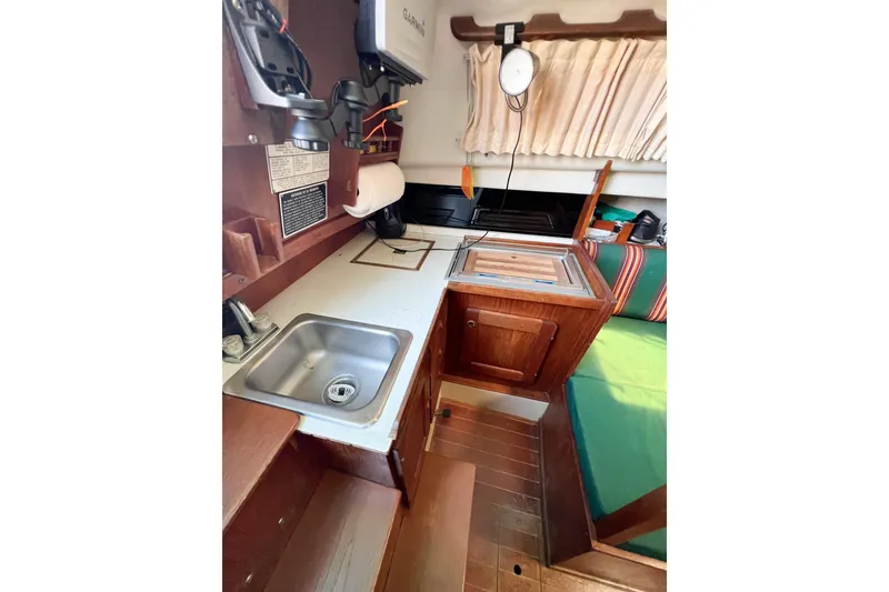 Slide: The Image of 1978 CAL 34 sailboat interior with kitchenette, sink, and wooden cabinetry. - 25