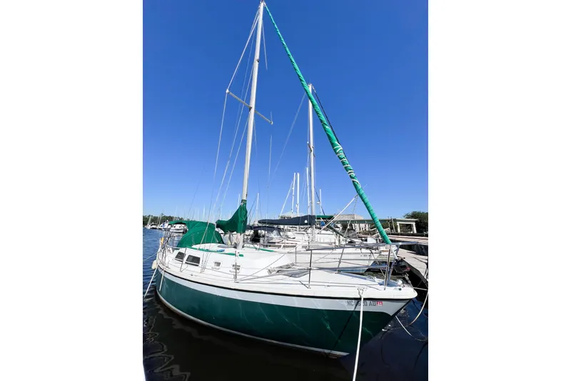 Slide: The Image of 1978 CAL 34 sailboat docked under clear blue sky. - 3
