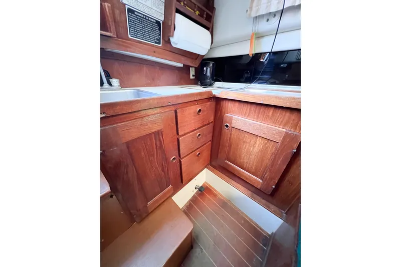 Slide: The Image of 1978 CAL 34 sailboat interior kitchen with wooden cabinets and sink. - 36