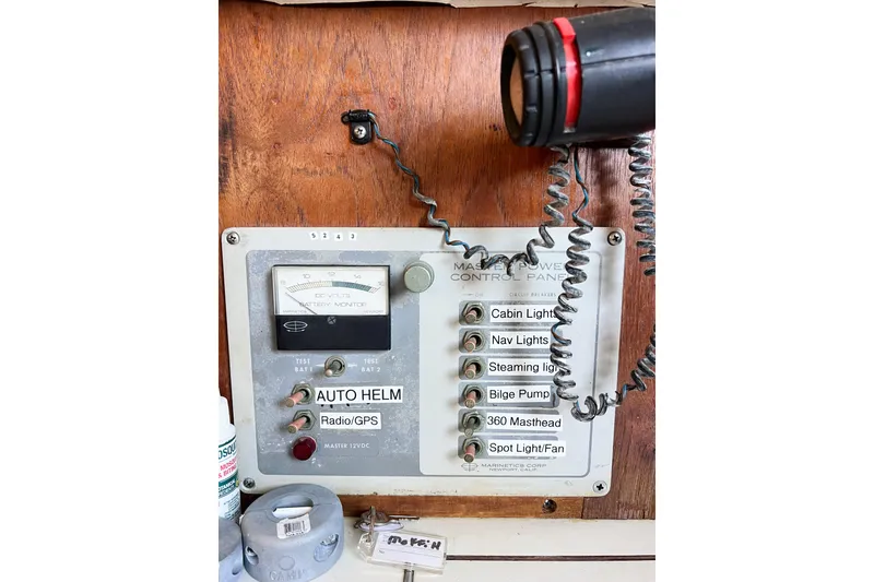 Slide: The Image of Control panel of a 1978 CAL 34 sailboat with switches and battery monitor. - 39