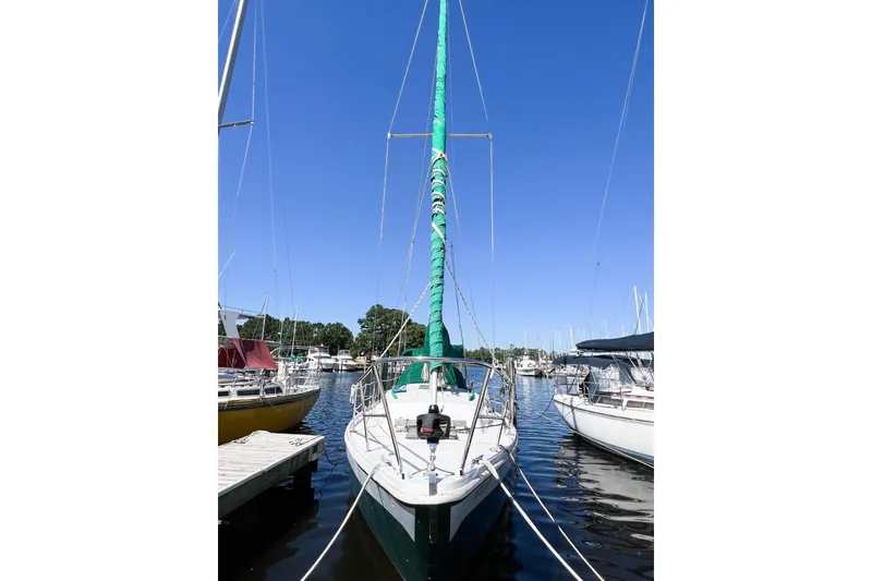 Slide: The Image of 1978 CAL 34 sailboat docked at marina under clear blue sky. - 4