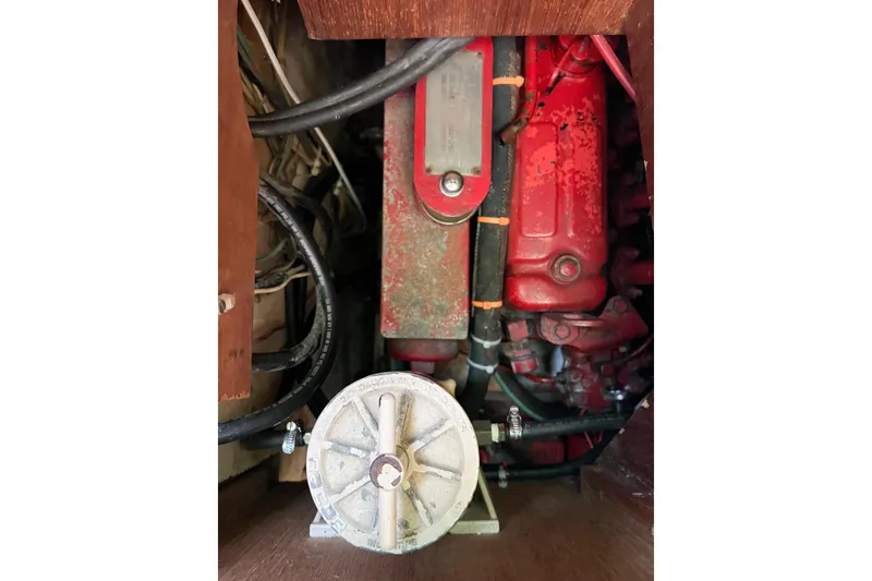 Slide: The Image of 1978 CAL 34 engine compartment with red engine and visible wiring. - 42