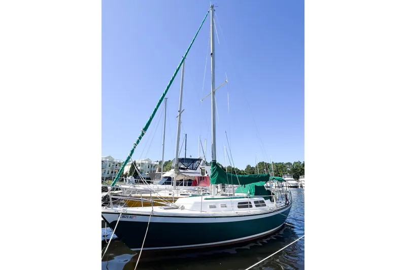 Slide: The Image of 1978 CAL 34 sailboat docked at marina under clear blue sky. - 5