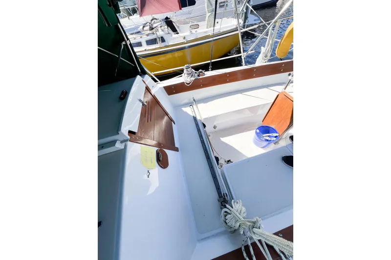Slide: The Image of 1978 CAL 34 sailboat cockpit with wooden accents and nautical equipment. - 9