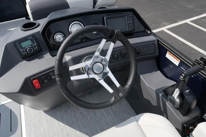 Slide: The Image of 2026 Bennington S Quad Bench 22 SSR interior with gray seating and central table. - 14