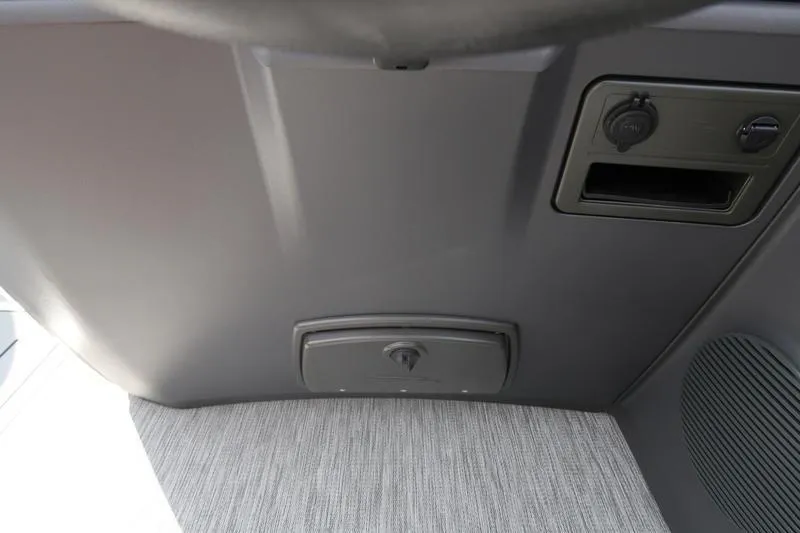 Slide: The Image of 2026 Bennington S Quad Bench 22 SSR boat interior with steering console and captain's chair. - 19