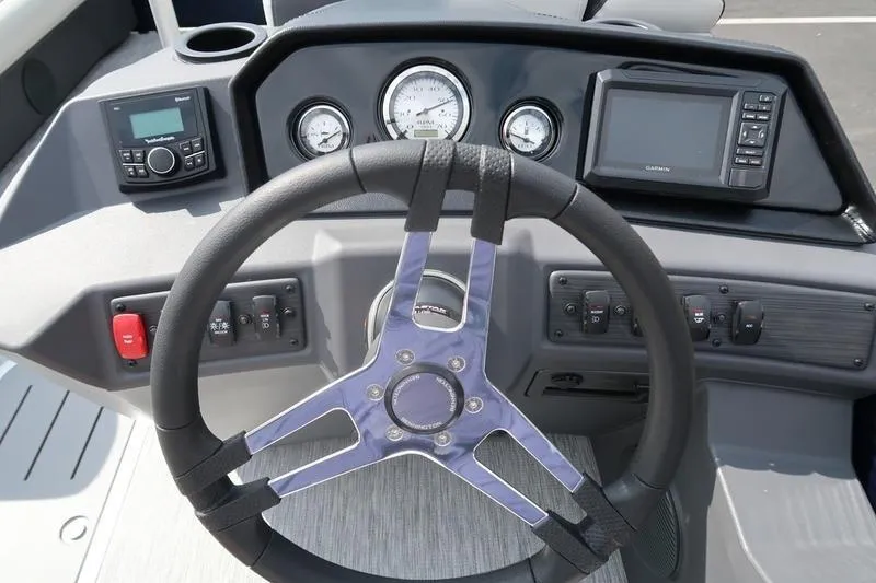 Slide: The Image of Steering console of 2026 Bennington S Quad Bench 22 SSR with gauges and controls. - 20