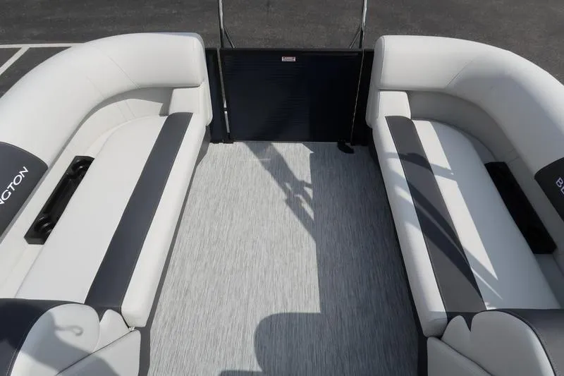 Slide: The Image of 2026 Bennington S Quad Bench 22 SSR interior dashboard detail with controls and speaker. - 22