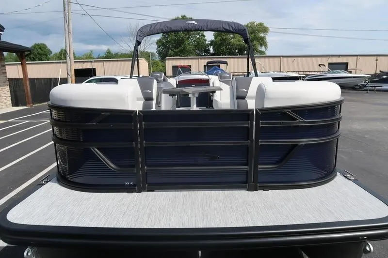 Slide: The Image of 2026 Bennington S Quad Bench 22 SSR pontoon boat with outboard motor in parking lot. - 3