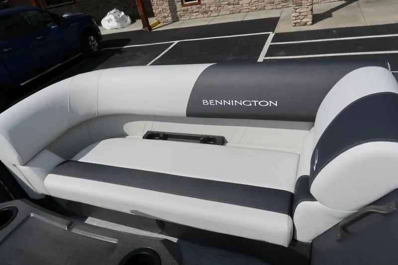 Slide: The Image of 2026 Bennington S Quad Bench 22 SSR pontoon boat interior with gray seating and table. - 8