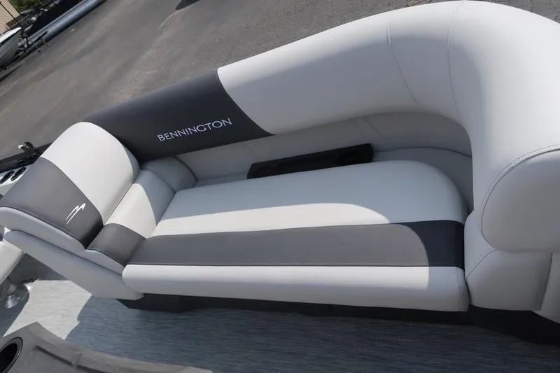 Slide: The Image of 2026 Bennington S Quad Bench 22 SSR pontoon boat, rear view in a parking lot. - 9