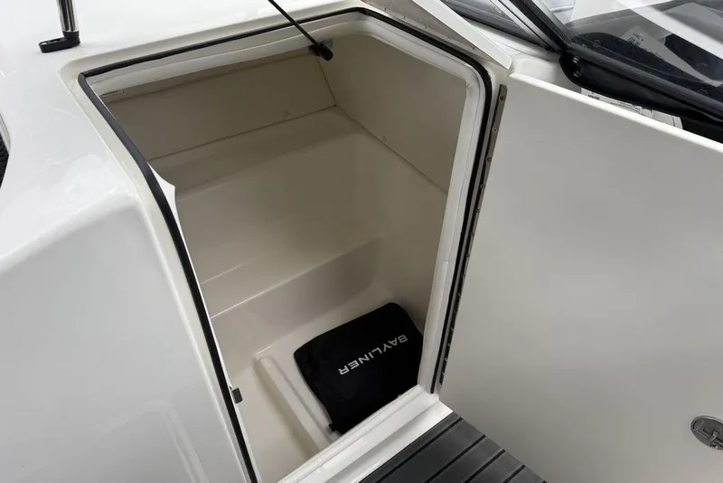 Slide: The Image of 2026 Bayliner VR6 Bowrider OB storage compartment with Bayliner-branded mat. - 10