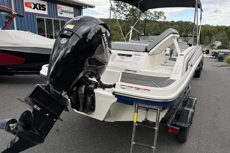 Slide: The Image of 2026 Bayliner VR6 Bowrider OB with Mercury outboard engine, parked on trailer. - 14