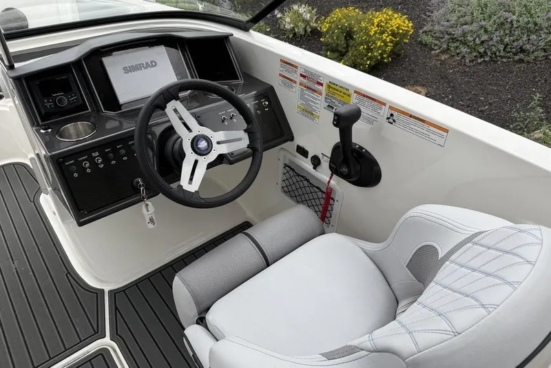 Slide: The Image of 2026 Bayliner VR6 Bowrider OB cockpit with steering wheel, controls, and Simrad display. - 3