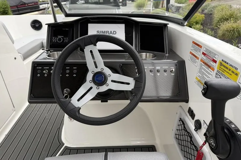 Slide: The Image of 2026 Bayliner VR6 Bowrider OB dashboard with steering wheel and control panel. - 7