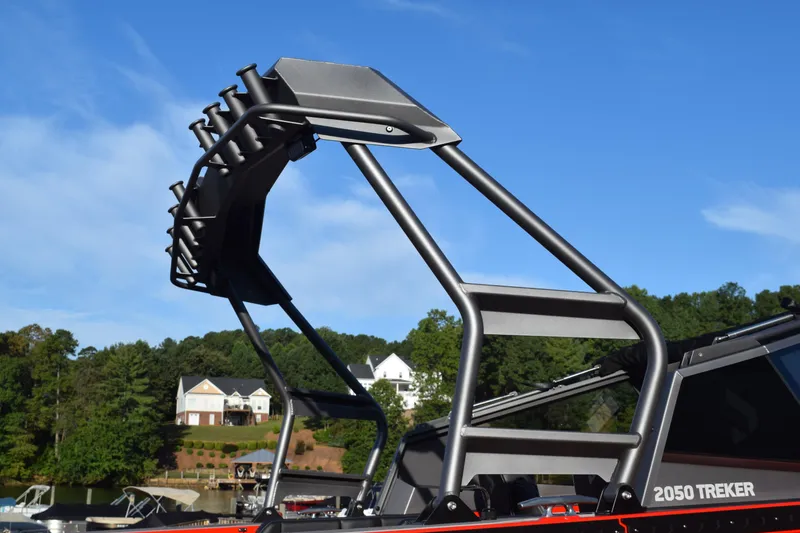 Slide: The Image of Stabicraft 2050 Treker Profish 2025 boat with rod holders against a clear blue sky. - 6