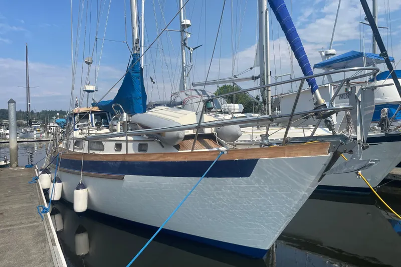 The Image of 1984 Slocum 43 sailboat docked at marina under clear sky. - 0