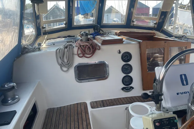 Slide: The Image of Cockpit of 1984 Slocum 43 sailboat with navigation instruments and ropes. - 13