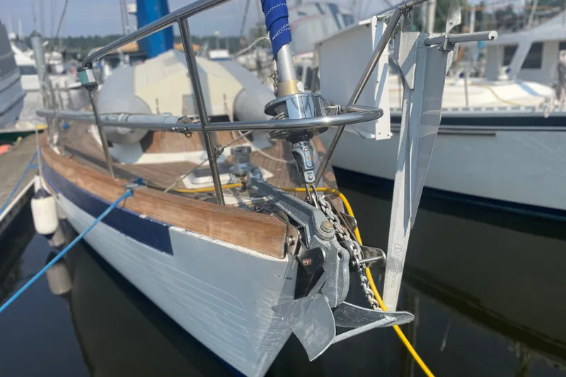 Slide: The Image of 1984 Slocum 43 sailboat docked, showcasing anchor and bow details. - 2