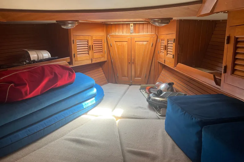 Slide: The Image of Cozy cabin interior of 1984 Slocum 43 sailboat with wooden paneling and cushions. - 27