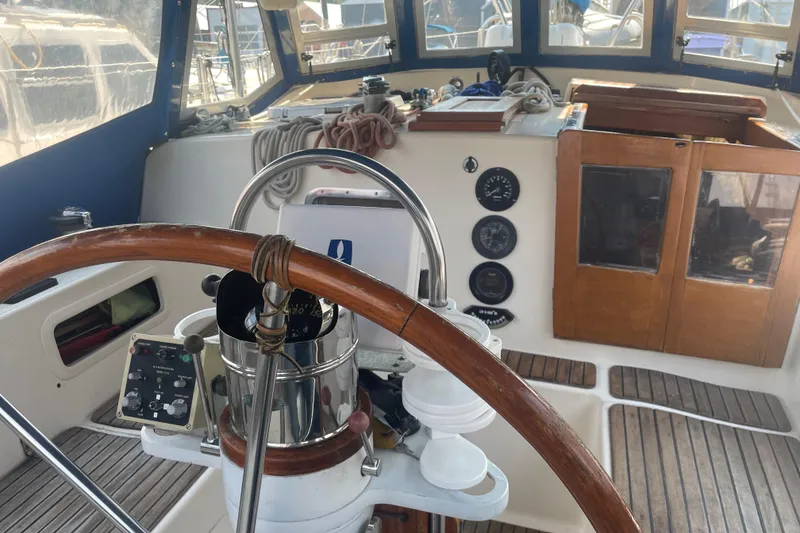 Slide: The Image of Cockpit of 1984 Slocum 43 sailboat with wooden wheel and navigation instruments. - 28