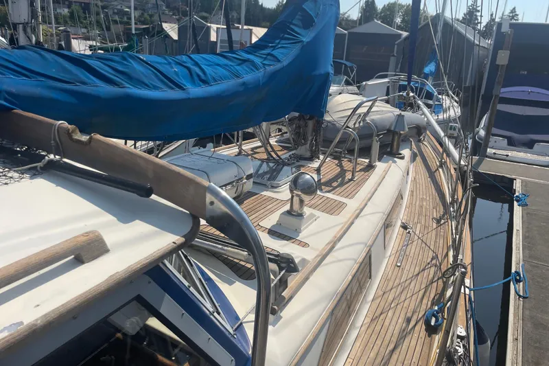 Slide: The Image of 1984 Slocum 43 sailboat with blue cover docked at marina. - 5