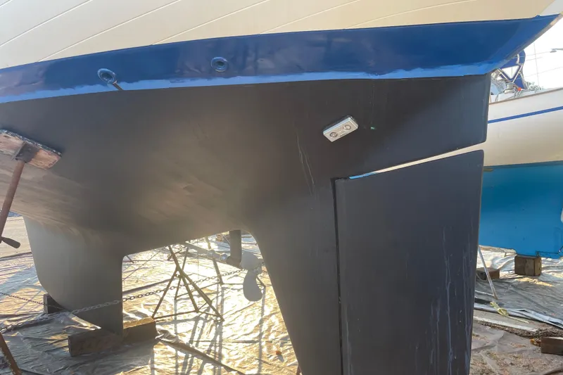 Slide: The Image of 1984 Slocum 43 sailboat hull and keel in dry dock, showing clean lines and structure. - 8