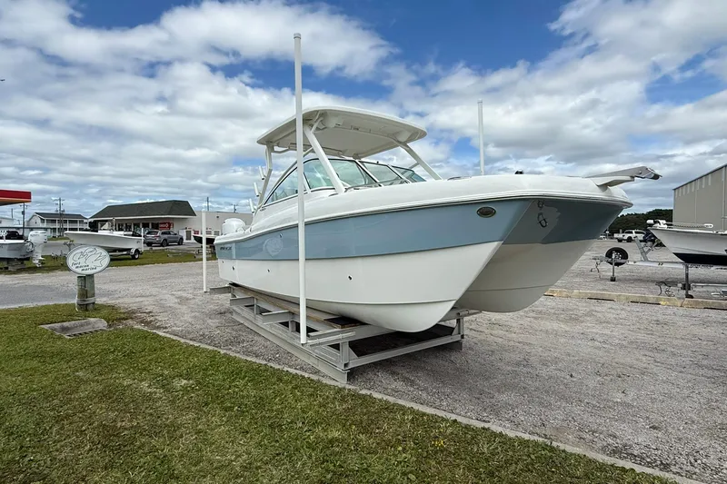 The Image of 2026 World Cat 230 DC boat displayed outdoors under a cloudy sky. - 1