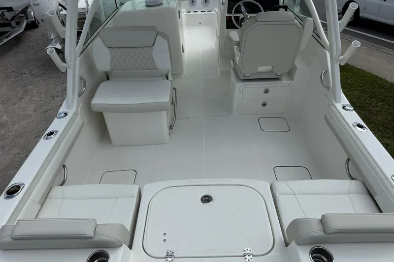 Slide: The Image of 2026 World Cat 230 DC boat interior with white seating and modern design. - 10