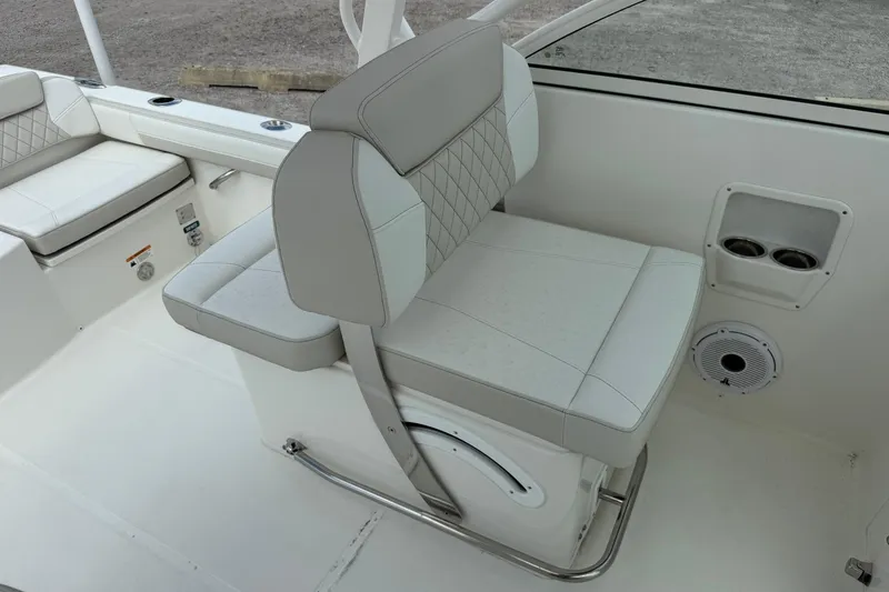 Slide: The Image of 2026 World Cat 230 DC boat interior with cushioned seating and cup holders. - 13