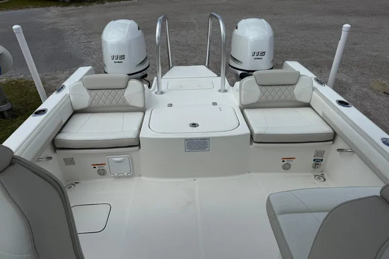 Slide: The Image of 2026 World Cat 230 DC boat interior with dual Yamaha 115 engines, featuring cushioned seating. - 14