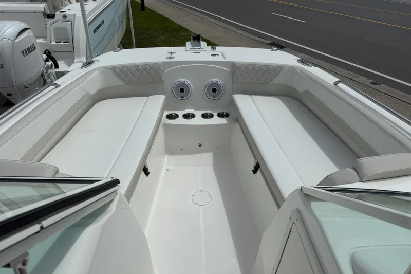 Slide: The Image of 2026 World Cat 230 DC boat interior with white seating and cup holders. - 17