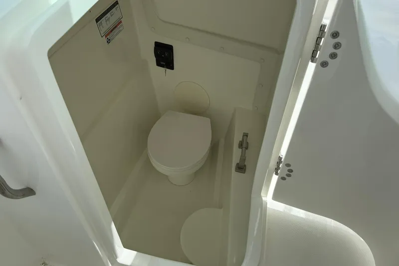 Slide: The Image of 2026 World Cat 230 DC boat interior with compact marine toilet. - 18