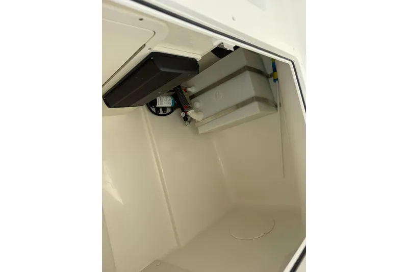 Slide: The Image of Interior view of 2026 World Cat 230 DC boat compartment, showcasing storage and equipment. - 19