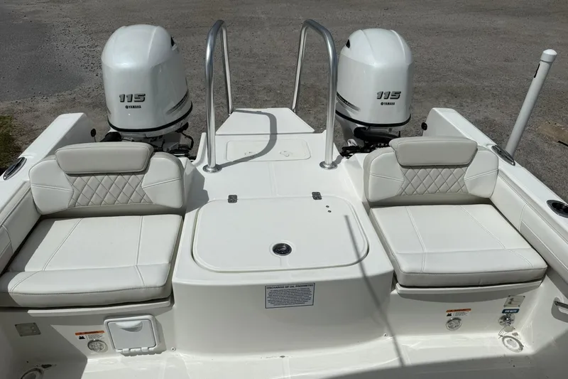 Slide: The Image of 2026 World Cat 230 DC boat with dual Yamaha 115 engines and cushioned seating. - 20