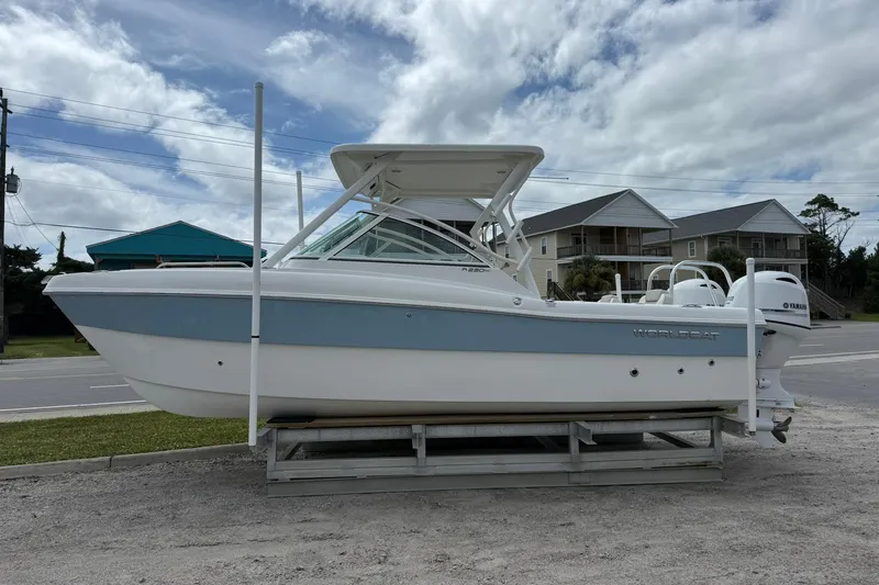 Slide: The Image of 2026 World Cat 230 DC boat on display, featuring sleek design and dual engines. - 4