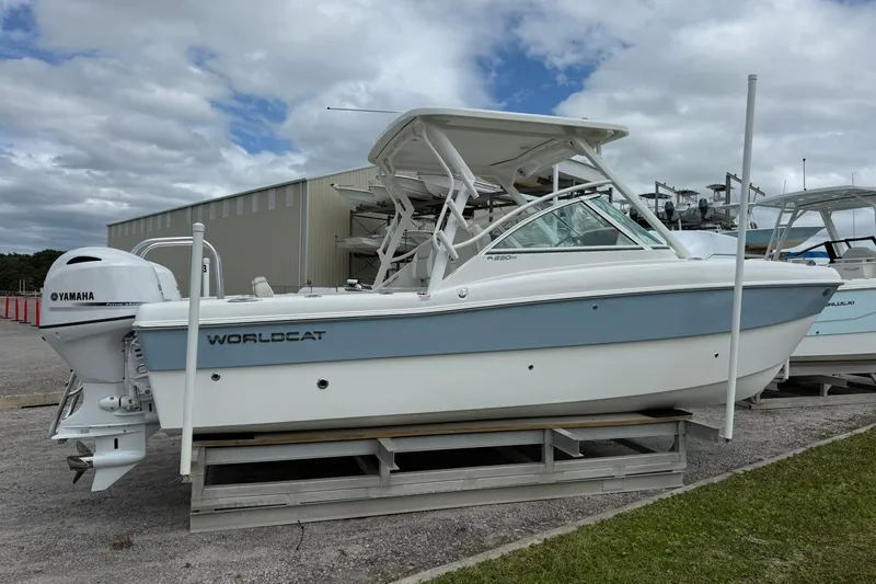 Slide: The Image of 2026 World Cat 230 DC boat with Yamaha engine, displayed outdoors on a stand. - 8