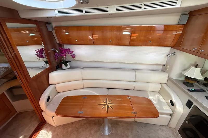 Slide: The Image of Luxurious interior of 2004 Regal Commodore 3860 yacht with elegant seating and wooden table. - 11