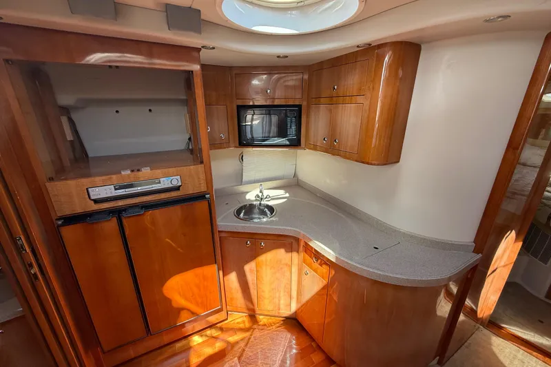 Slide: The Image of Luxurious 2004 Regal Commodore 3860 yacht kitchen with wood cabinetry and modern appliances. - 12