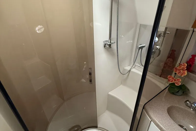 Slide: The Image of Shower area in 2004 Regal Commodore 3860 yacht with modern fixtures and floral decor. - 17