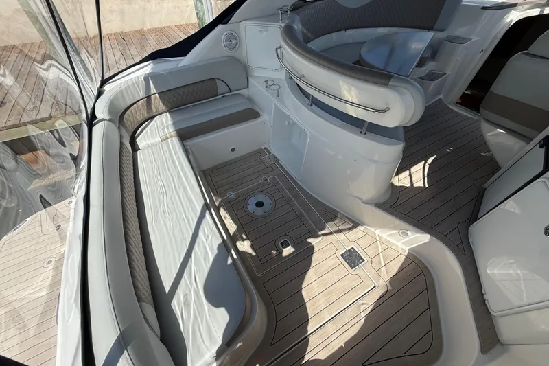 Slide: The Image of 2004 Regal Commodore 3860 boat interior with cushioned seating and wood-patterned flooring. - 2
