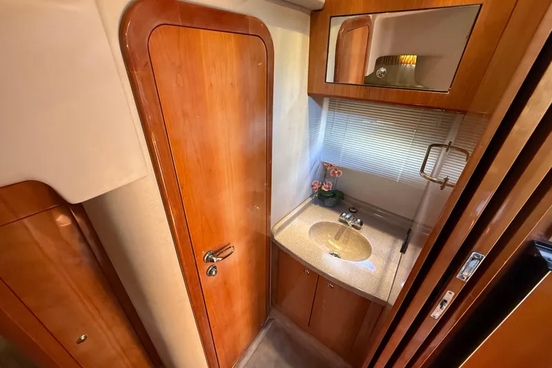 Slide: The Image of Luxurious 2004 Regal Commodore 3860 yacht bathroom with wooden cabinetry and modern sink. - 20