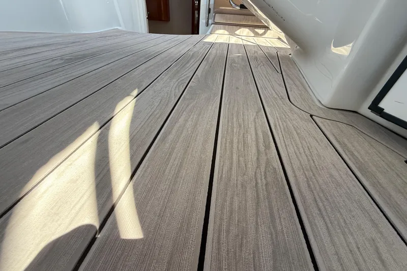 Slide: The Image of Teak deck of 2004 Regal Commodore 3860 yacht, showcasing elegant wood finish. - 25