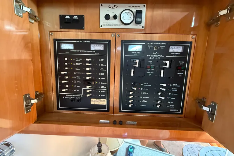 Slide: The Image of Electrical control panel of a 2004 Regal Commodore 3860 boat, featuring switches and gauges. - 28