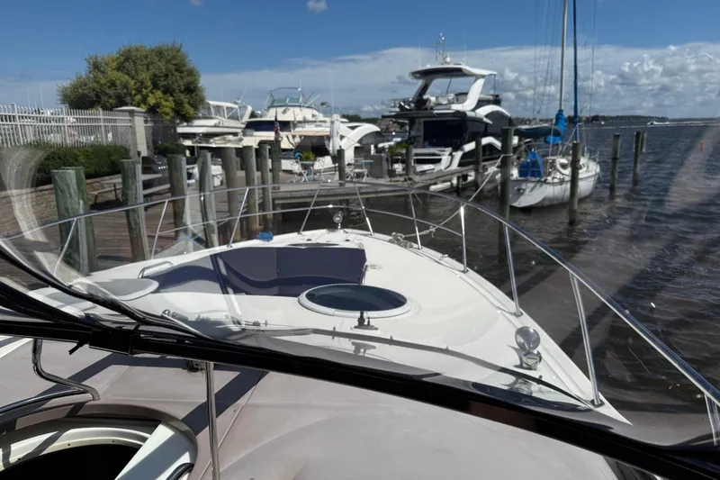 Slide: The Image of 2004 Regal Commodore 3860 yacht docked at a marina on a sunny day. - 29