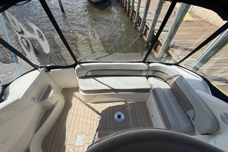 Slide: The Image of 2004 Regal Commodore 3860 boat interior with seating and wood flooring at dock. - 3