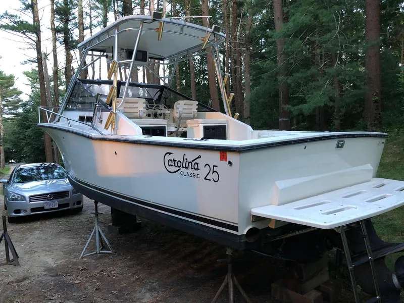 Slide: The Image of 2002 Carolina Classic 25 boat on stands in a wooded area. - 2