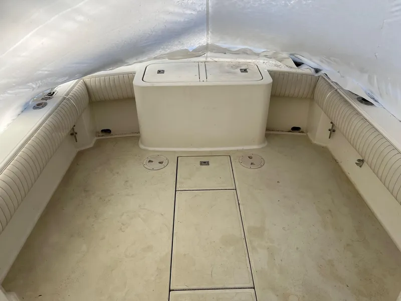 Slide: The Image of 2002 Carolina Classic 25 Classic boat interior with cushioned seating and storage compartments. - 5