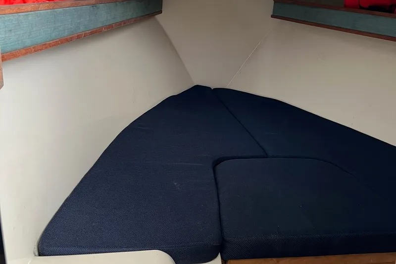 Slide: The Image of 2002 Carolina Classic 25 Classic boat interior with blue cushioned seating. - 6