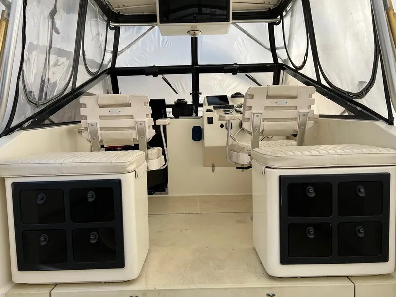 Slide: The Image of 2002 Carolina Classic 25 Classic boat interior with seating and storage compartments. - 8